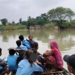 खगड़िया में बाढ़ के बीच नाव से स्कूल जाते बच्चे